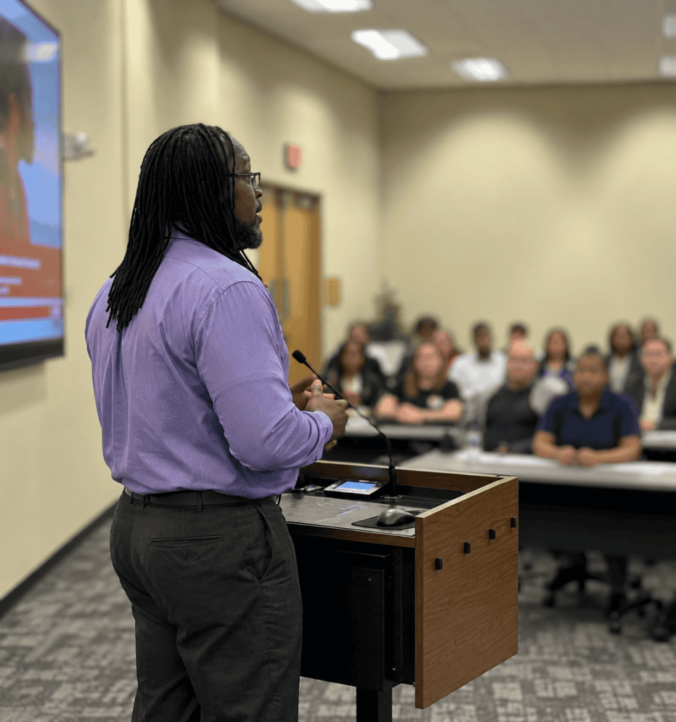 James D Sanders delivering a presentation to an engaged audience.