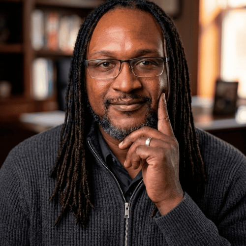 profile shot of James sanders set against a blurred office style background with a blurred bookcase in the background